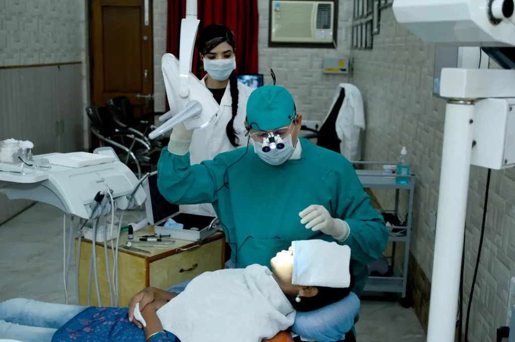 Dr. Gaurav performing surgery in a modern treatment room with dental chair and advanced equipment