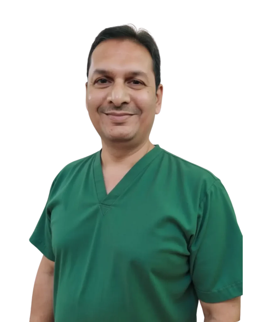 Portrait of Dr. Gaurav Gupta in green scrubs, expert in dental crowns and bridges in Varanasi