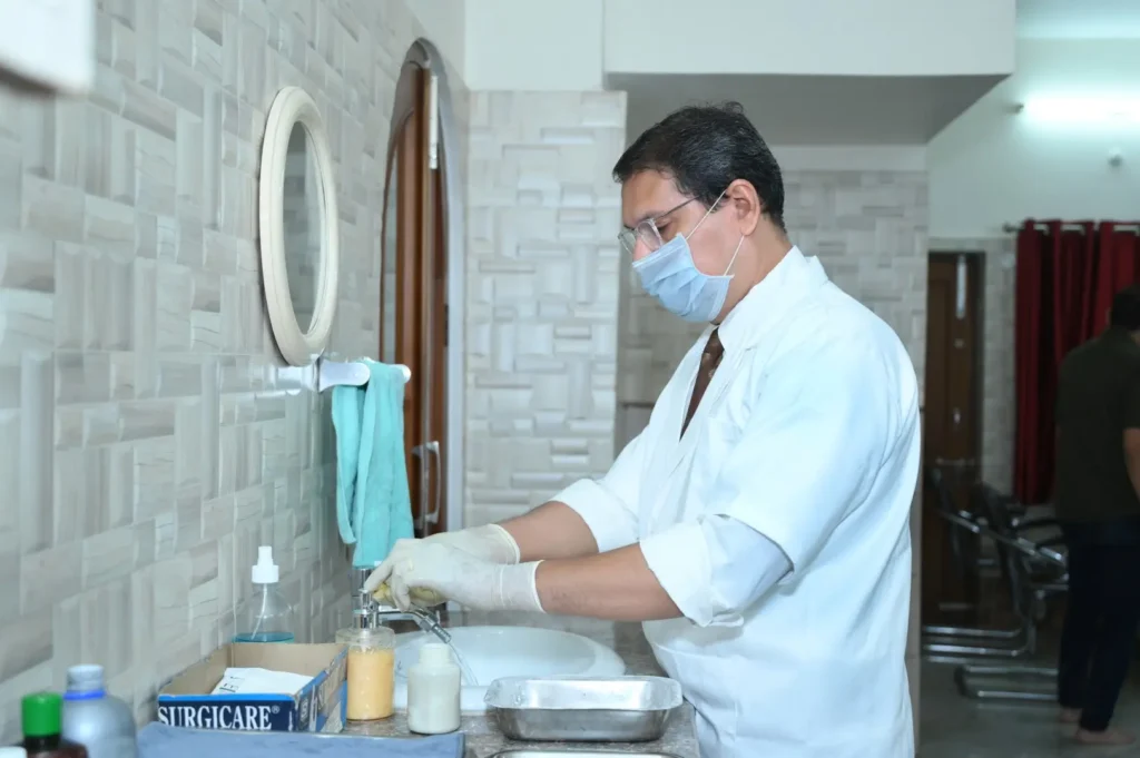 Dr Gaurav scrubbing hands in sterilization zone before procedure at Varanasi clinic