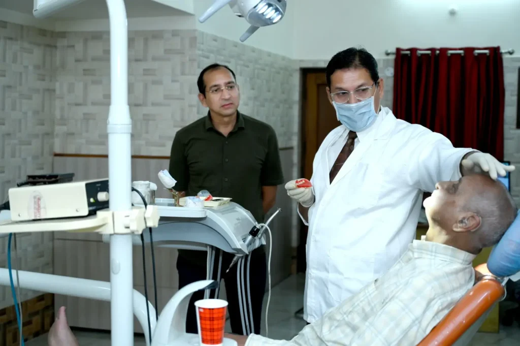 Dr. Gaurav explaining treatment using prosthetic model.
