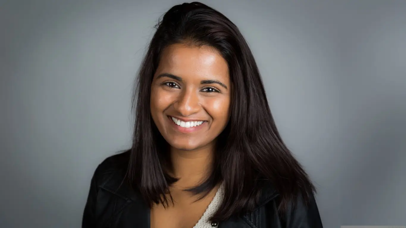 Confident patient displaying straight teeth after orthodontic care