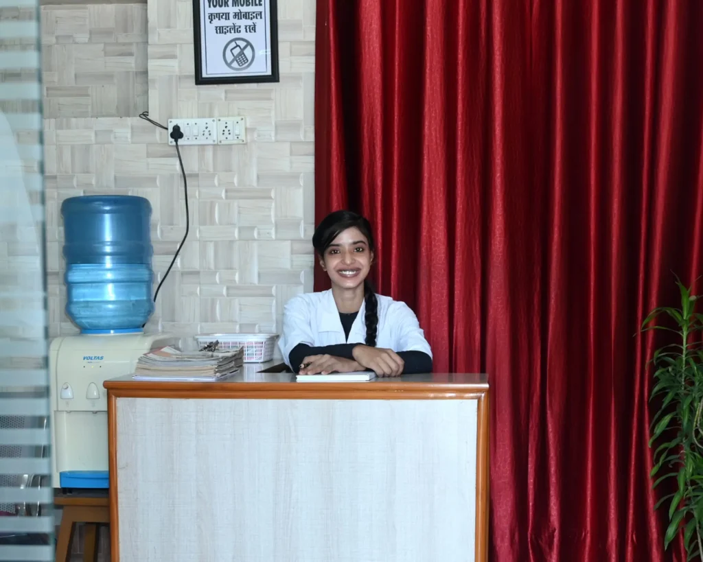 Friendly receptionist welcoming patients at Dr Gaurav Dental Clinic's reception desk in Varanasi