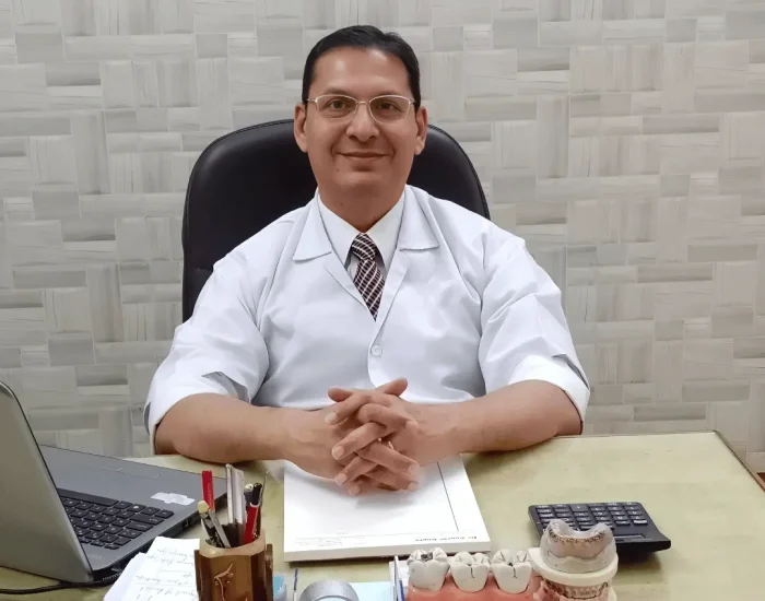 Dr Gaurav Gupta sitting at his desk during dental consultation at his Varanasi dental clinic